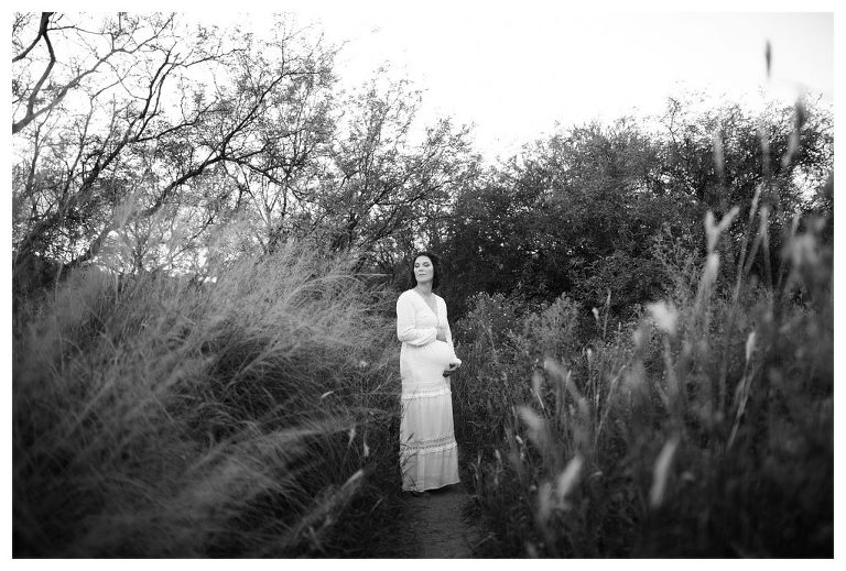 Boho-inspired outdoor maternity pictures in wildflower meadow at sunset in Sierra Vista, Arizona by Hannah Whaley Photography. 