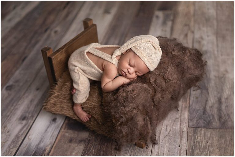 Newborn posing cream and dark brown in studio in Sierra Vista, Arizona.